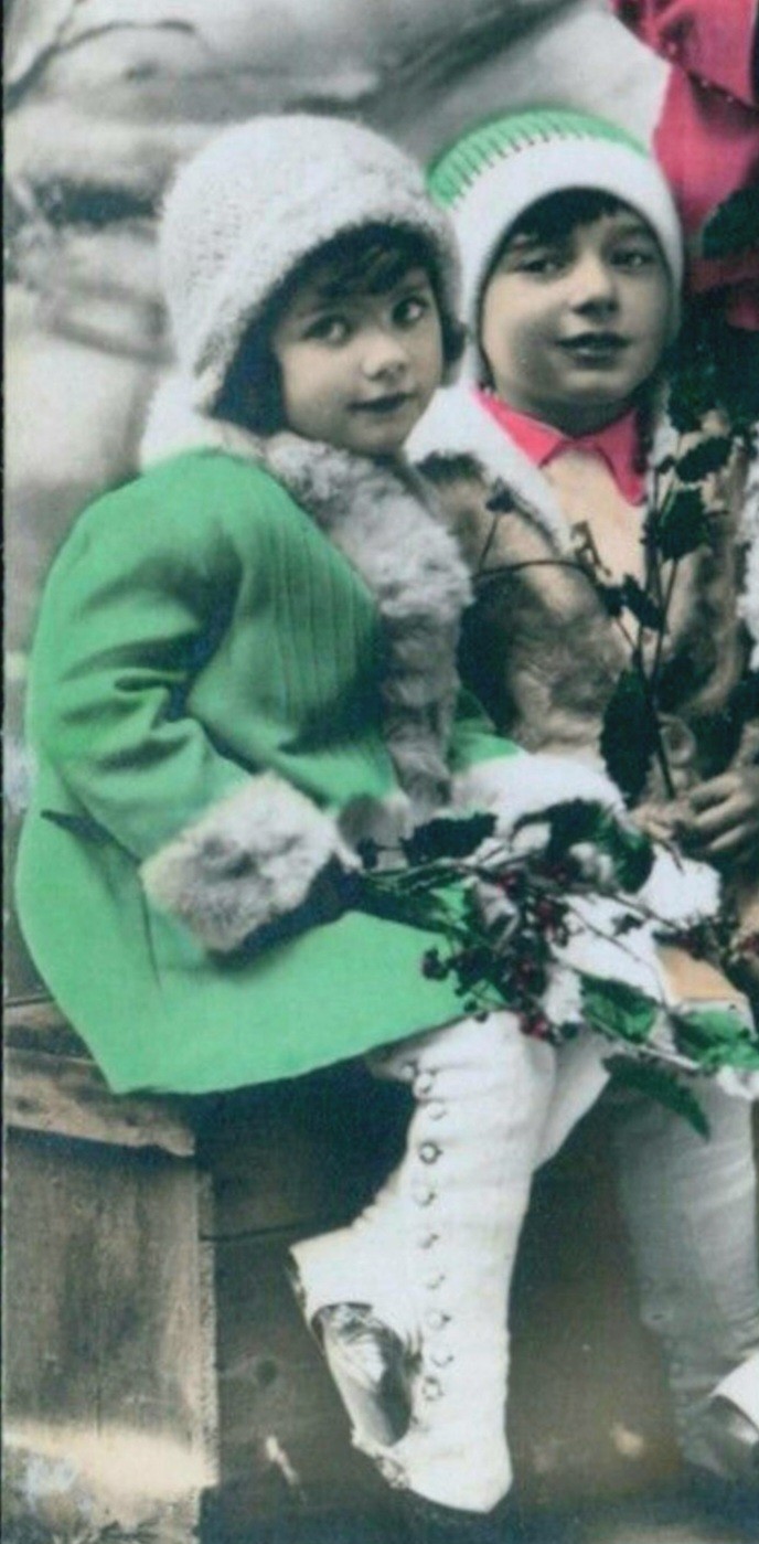 picture of little girl in photo from over a century ago wearing cozy looking mint snow dress