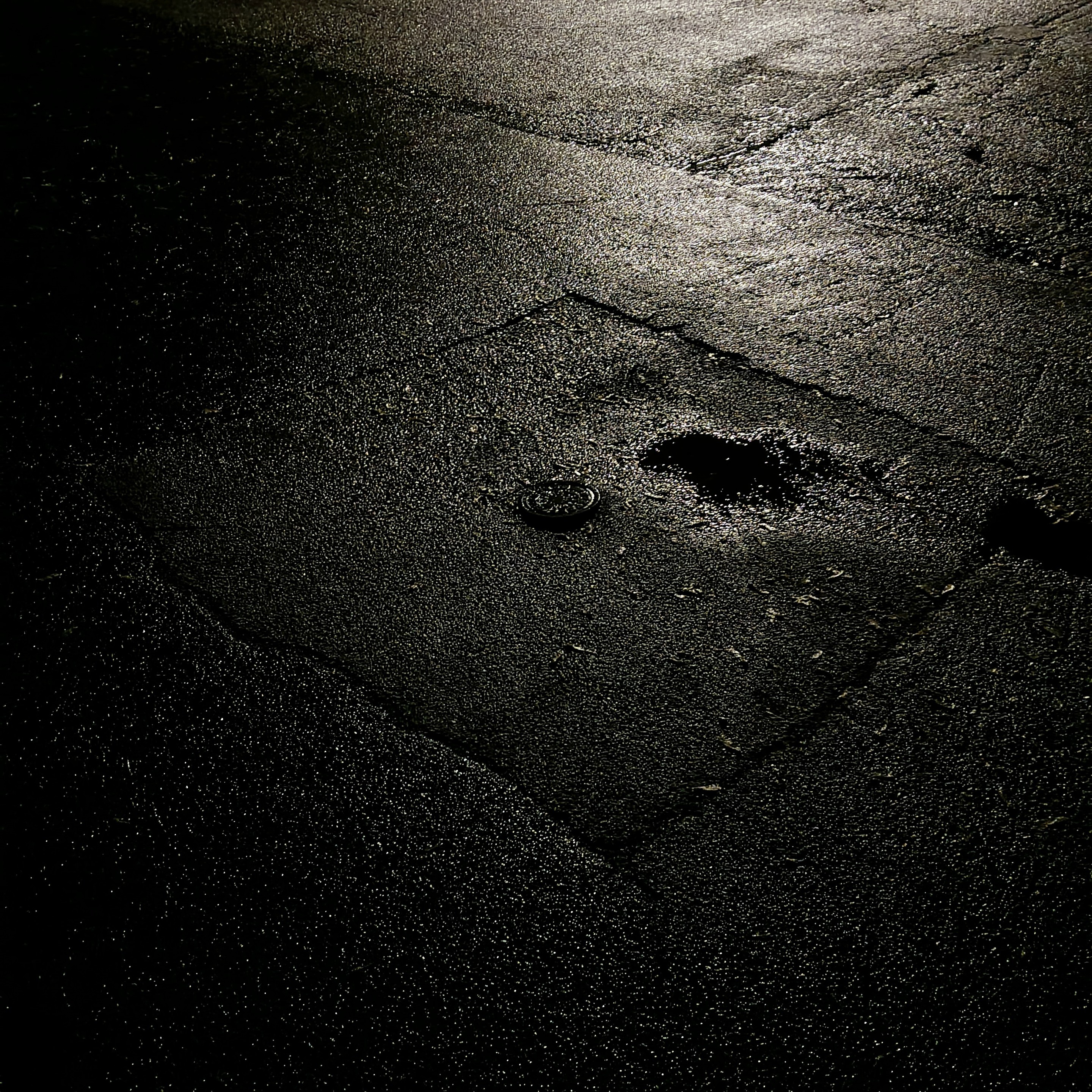 the reflection of light upon the post storm road produces many small flashes