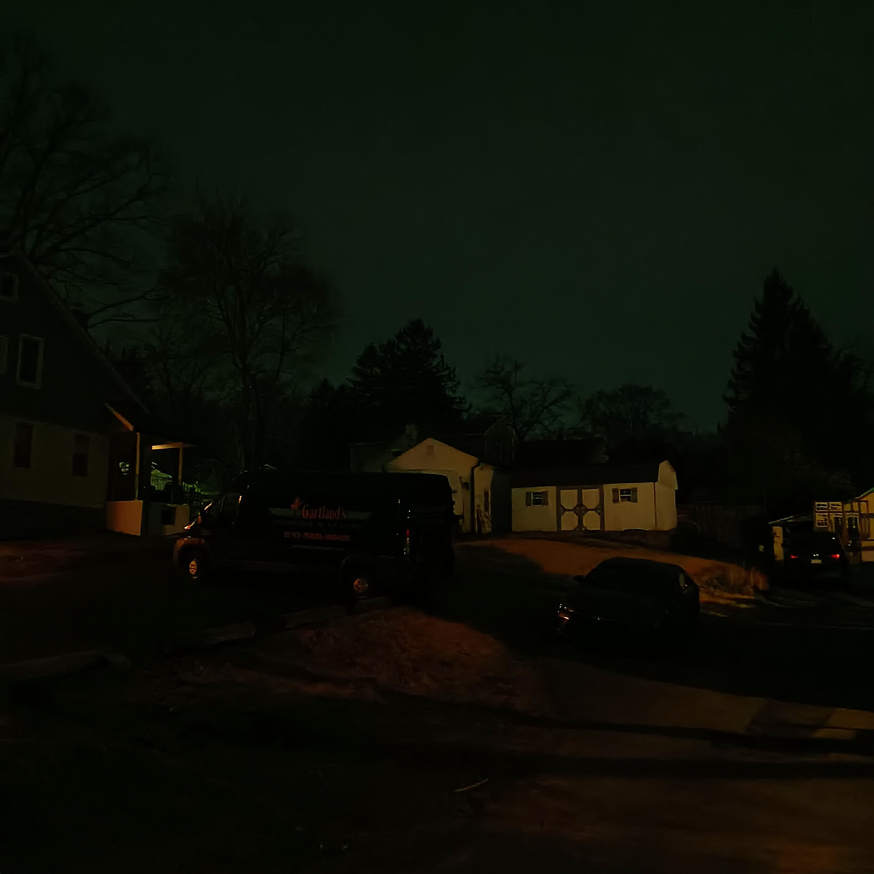 various sheds and vehicles littered on the hill