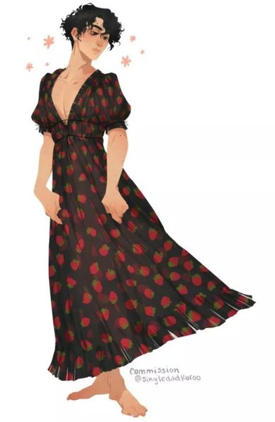 A person with curly black hair wearing a flowing black dress adorned with red strawberry patterns. They stand barefoot, surrounded by small pink flowers.