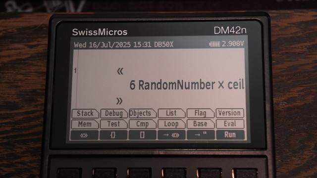 A picture of the display on the SwissMicros DM42n showing a very simple program that rolls a d6.