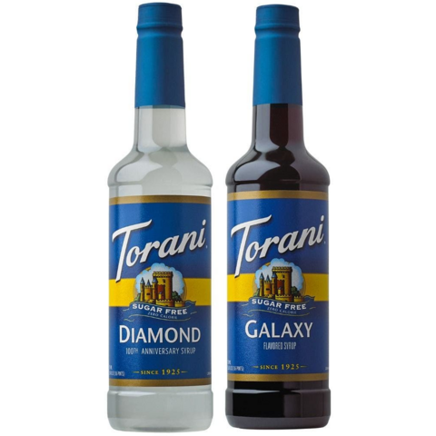 Two bottles of Torani brand syrup. One is white & labelled "Diamond" while the other is dark & labelled "Galaxy."