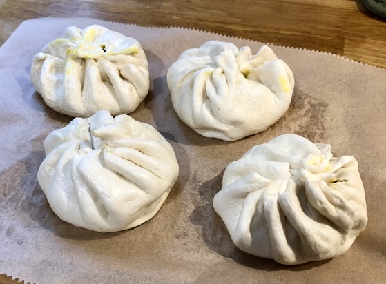 Four freshly steamed banh bao (with vegetable curry inside). Ugly as fuck.