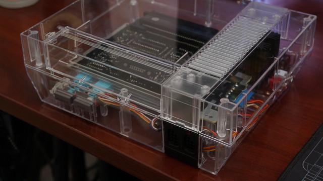 A picture of a frontloader NES in a clear acrylic shell.  It's missing the loading mechanism.