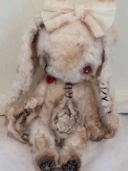 torn up droopy stuffed bunny with a bow