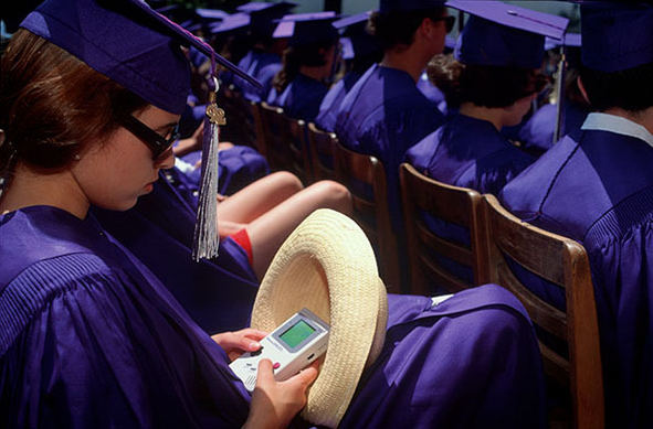 she's playing a gameboy hidden in her hat