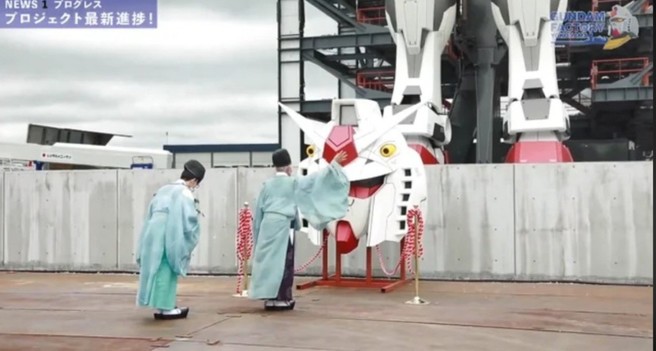 shinto priests blessing gundam figure head