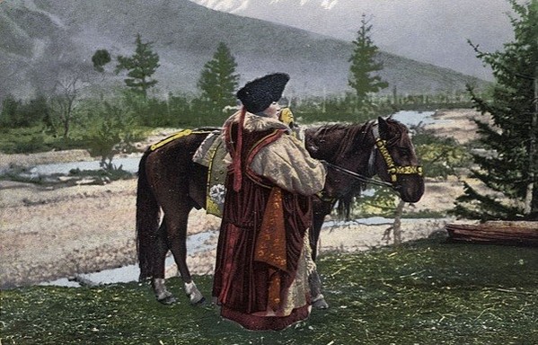 woman in national dress with horse