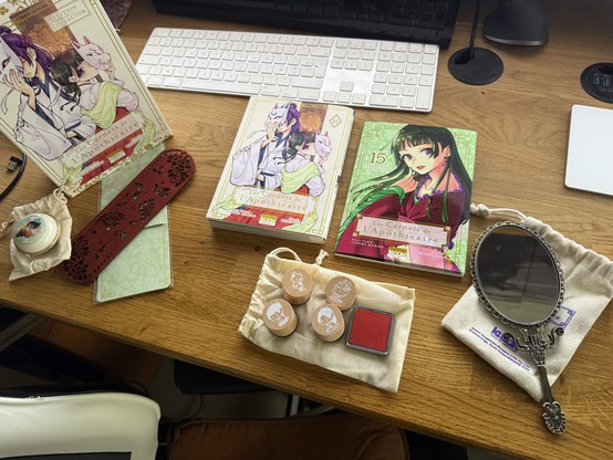 Everything that came with this vol 15 collector edition: an illustration booklet, a tiny illustrated box, a wooden bookmark, a hand mirror (seriously), and a set of ink stamps