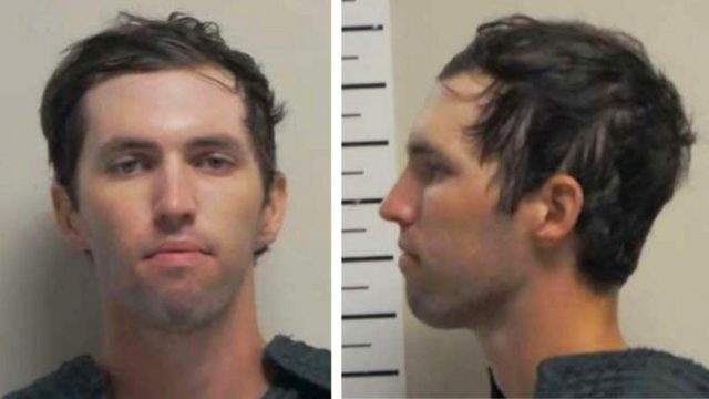 A white man with a wide forehead. Neutral facial expression. Looks to be in his mid 20s.