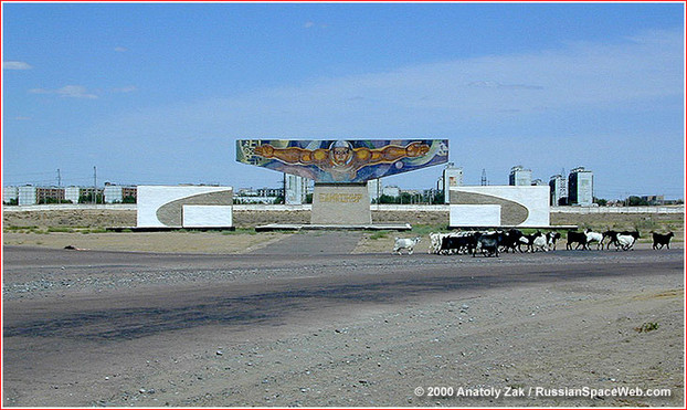 The monument informally known as "fisherman" greets visitors to Baikonur on their way from the Krainiy airport. According to a local joke, the cosmonaut on the mural brags about the size of the fish he caught in the nearby Syr Darya River. Copyright © 2001 Anatoly Zak