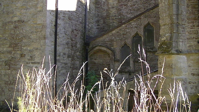3 ascending windows from a bricked up arched doorway, probly a staircase at the back of a church. 