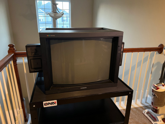 The Sony PVM-2530 sitting on an AV cart with its speakers attached.
