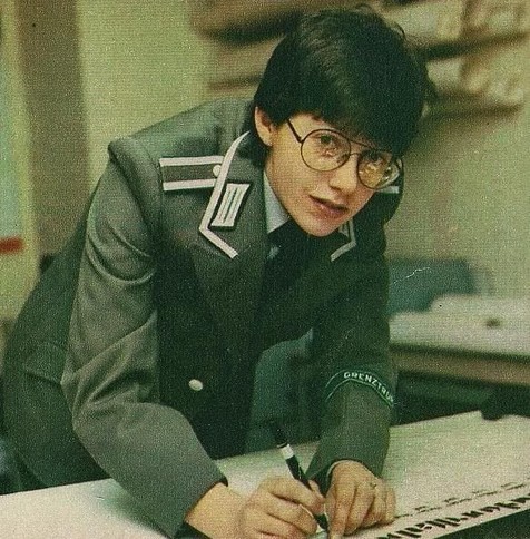 androgynous, snazzy suit, writing shit about u