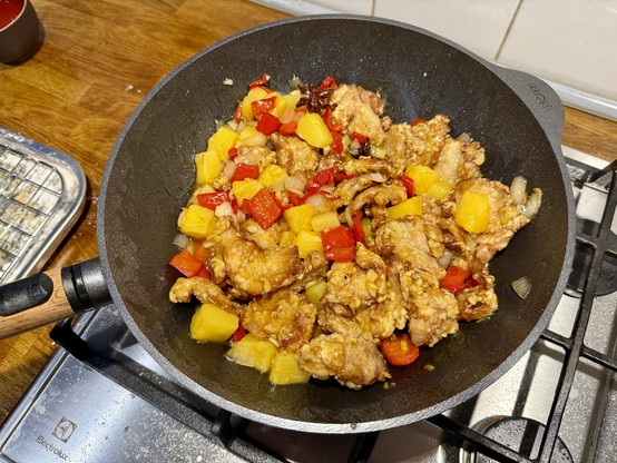 Sweet & sour pork in a wok, in all its red (bell pepper) and yellow (pineapple) glory