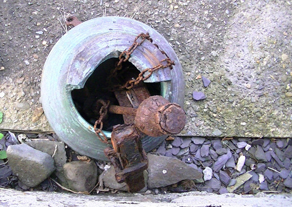 a broken church bell on the ground, view from above