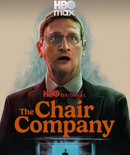 Promotional artwork for "The Chair Company," featuring a man in a suit with glasses and a concerned expression.