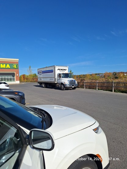 The truck parked on the wrong side of a laneway, and the driver walked to a store.