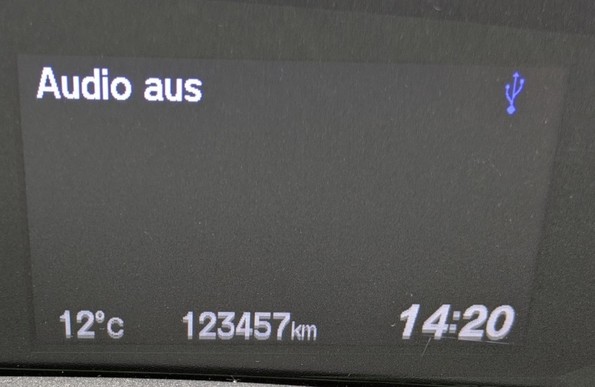 An odometer of a car showing 123457km
