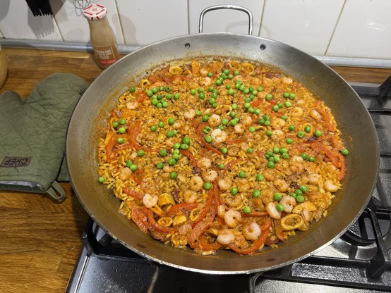 Home made paella with some peas on top just for the color contrast