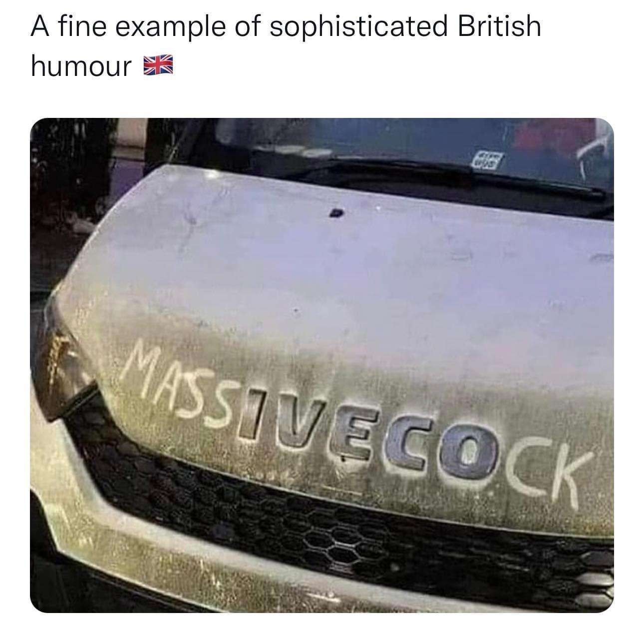 This picture shows the front of a previously white transporter which hood is spoiled with dirt. It's branded as an Iveco and someone painted MASS before and CK after the brand name into the dirt, which makes it "massive cock". Above the picture of the car is written "A fine example of sophisticated British humor" followed by the british union jack flag.