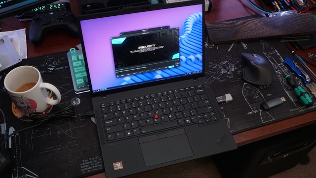 A picture of the Lenovo Thinkpad P14s Gen 6 on a slightly dirty deskmat showing the CachyOS install screen as it installs Linux.