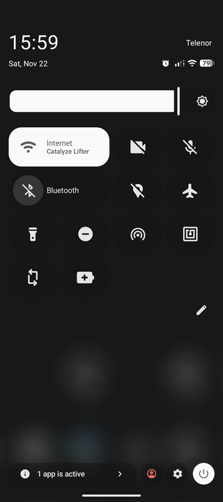 A smartphone screen showing a dark-themed control panel with time, date, network, battery status, and icons for Wi-Fi, Bluetooth, and settings.