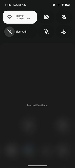 A smartphone screen showing a dark-themed control panel with time, date, network, battery status, and icons for Wi-Fi, Bluetooth, and settings.