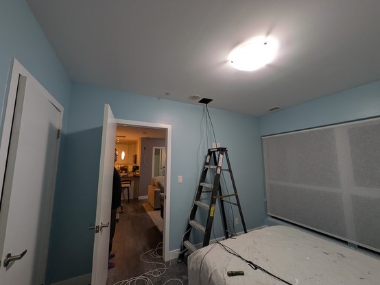 Snaking wire from an above ceiling cavity down to the bedroom which shares a wall with the TV.