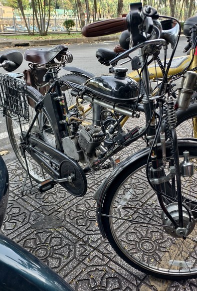 A Phoenix bicycle from the Netherlands, fitted with a small gas powered engine, similar to a Solex. Seen in Saigon, Vietnam
