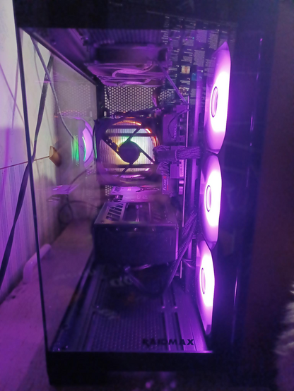 View from the front glass panel, the purple fans are on the right. You can see through the heat sink fans to the exhaust fan at the back. The Thicc GPU (9070XT) sits under the heat sink.