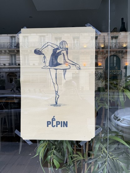 A drawing taped to a "caviste" (wine store) window. A ballerina with long hair (can't see her face) is tiptoeing on her right leg; the left one is folded so that the lower leg is horizontal. A wine glass stands on her foot, and she's pouring wine from a bottle in it