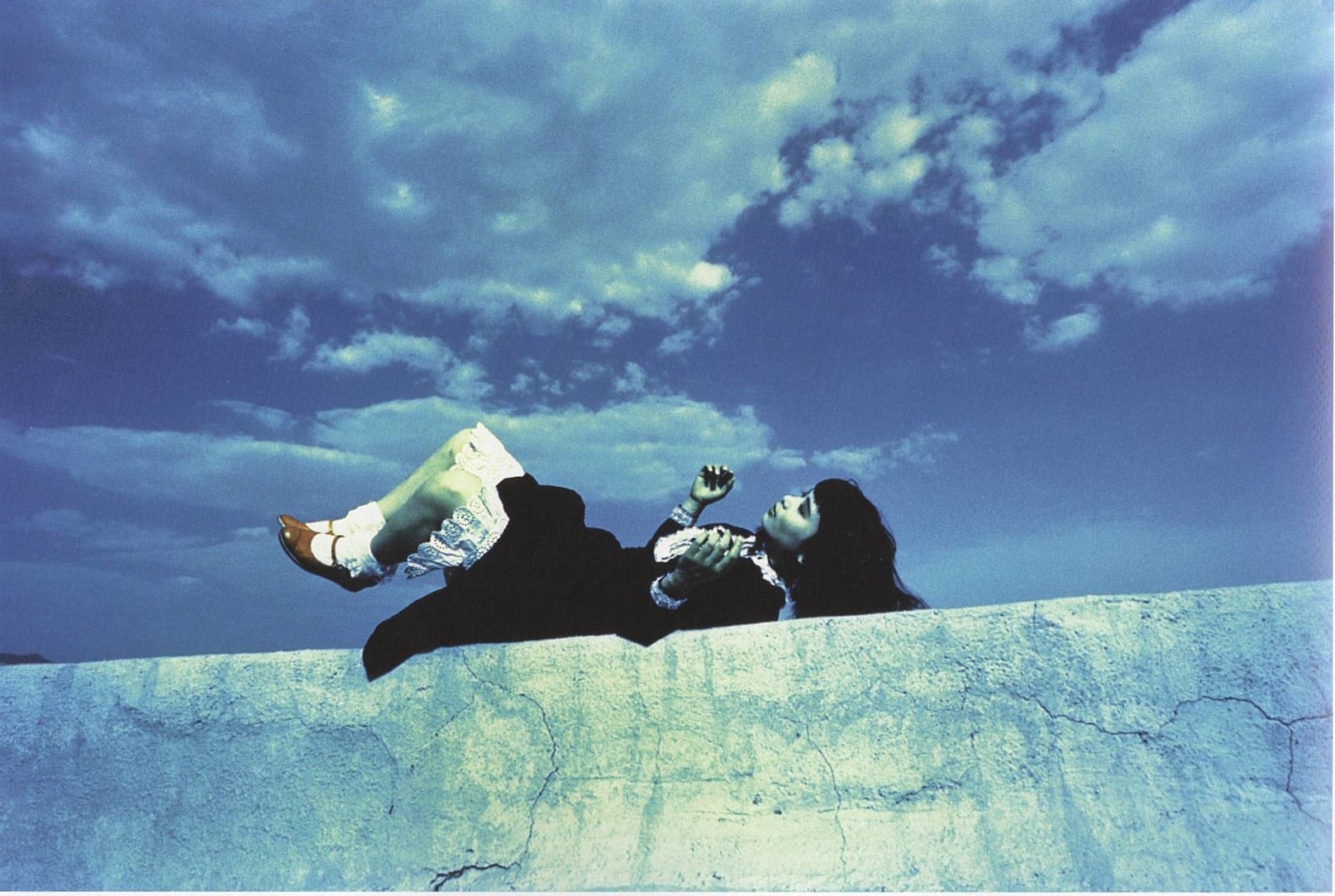 blue-ish green-ish colors for the woman on the wall, black hair black dress