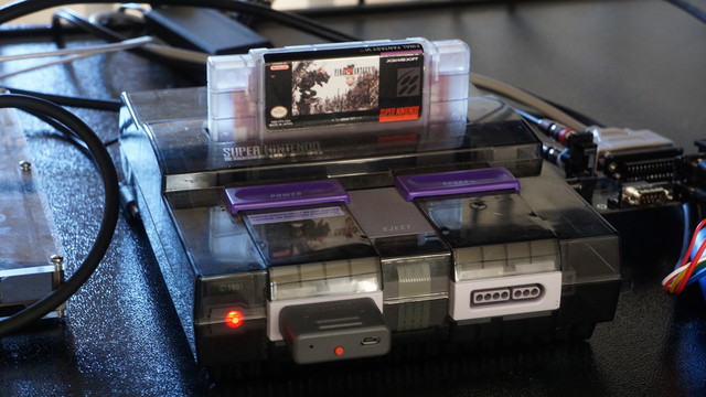 A Super Nintendo in a custom smoked acrylic shell running a custom translation of FF6 in a custom cart.