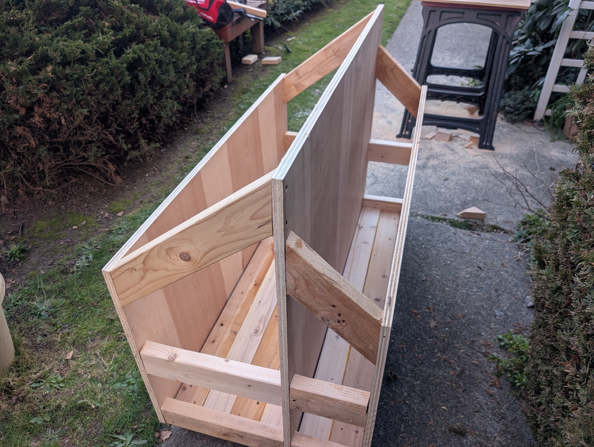 The wood cart. 2x4s make the floor and braces. Plywood acts as the sides. It has two compartments.