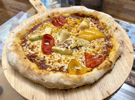 Home made pizza with artichokes and red bell peppers