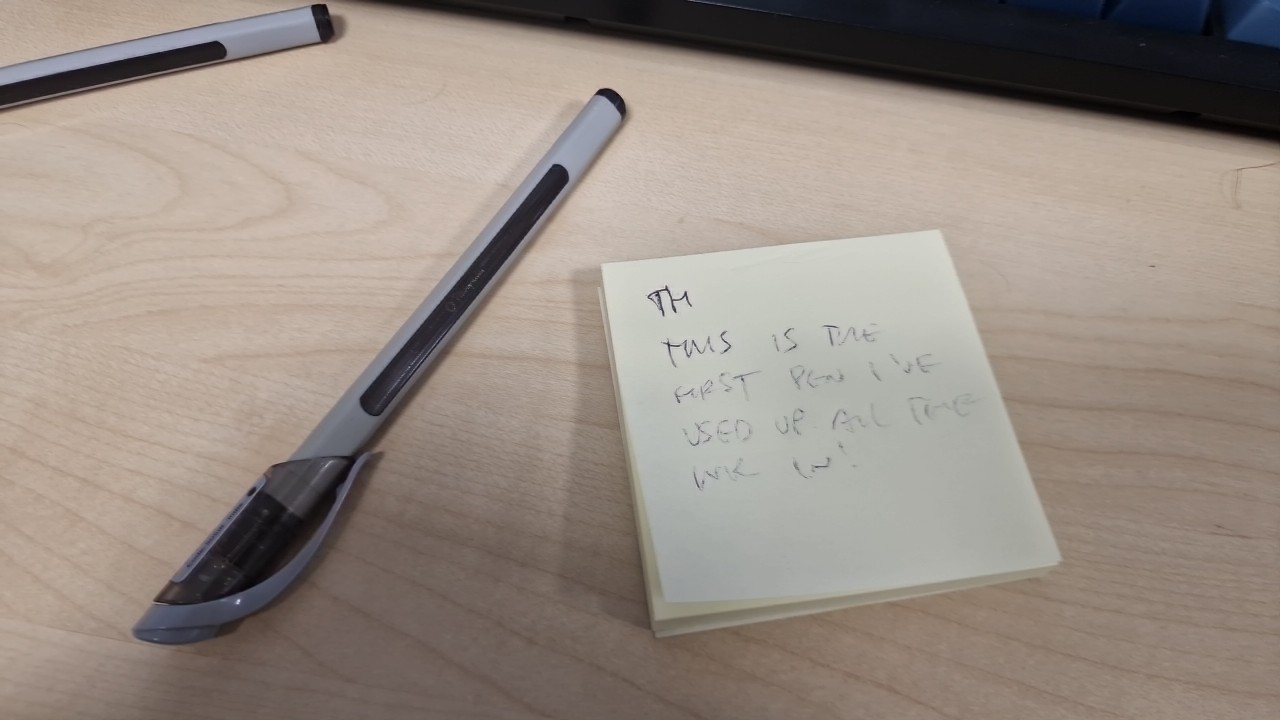 The finished pen and a post it with 'This is the first pen I've used up all the ink in!' thinly written on it