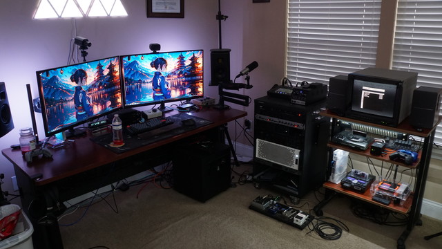 A picture of the office with the desk (two monitors), the audio rack, and the printer stand with the JVC PVM and consoles on it.