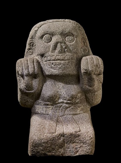 15th/early 16th carving of an Aztec cihuateotl, spirits of women who died in childbirth. skull smile, pawlike hands, blocky body