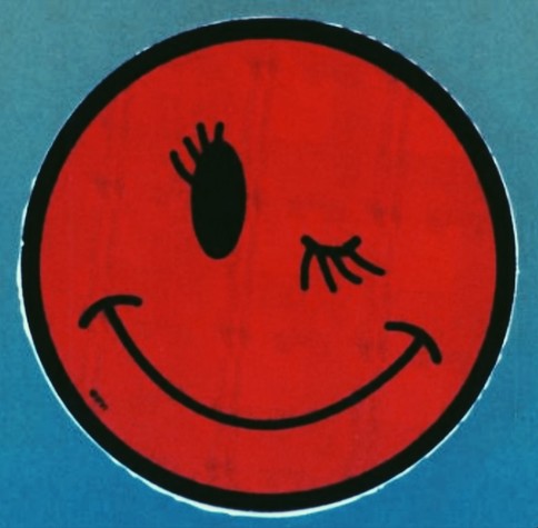 red smiley with eyelashes. one eye is closed for da wink. the background is sort of cyan light blue type shit