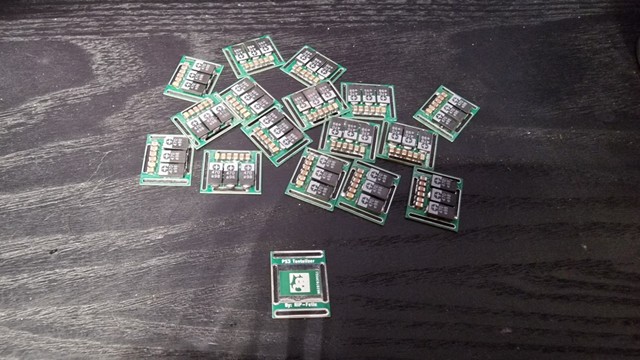 16 PS3 Tantalizers, designed by RIP-Felix, with all the caps soldered on. One empty board on its back shows the nickname and the icon of the creator and board designer.