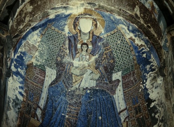 shot from the color of pomegranates of old religious art of the virgin mary missing its face