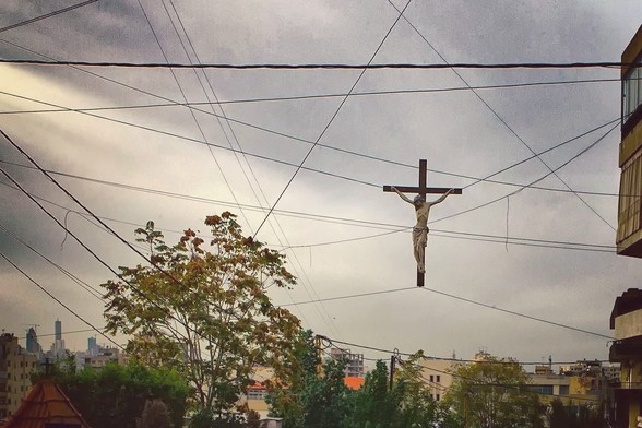 crucifix jesus on cross suspended in wires outside apartment
