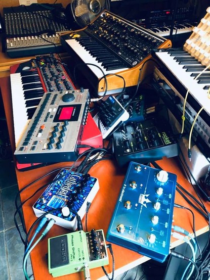 Various pieces of music gear, synths, and guitat pedals
