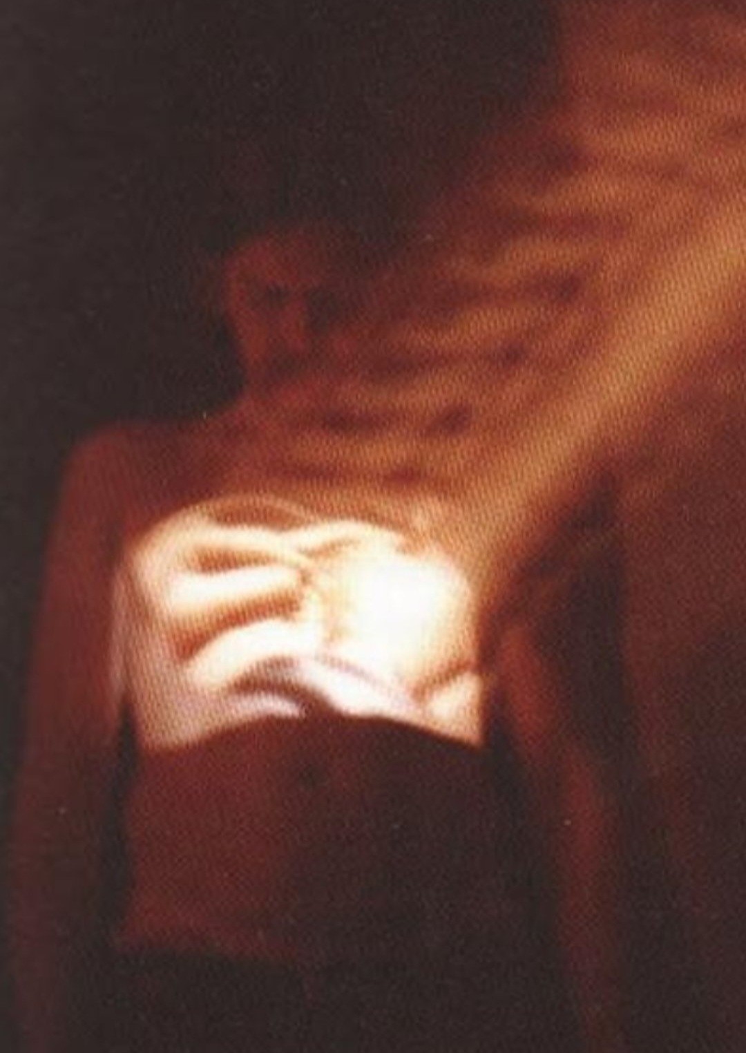 glowing orange, shifting frame, light on the nude skinless flesh