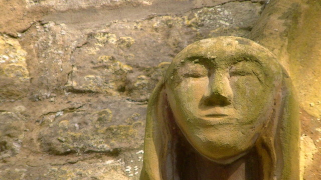 exterior stone face next to a church window