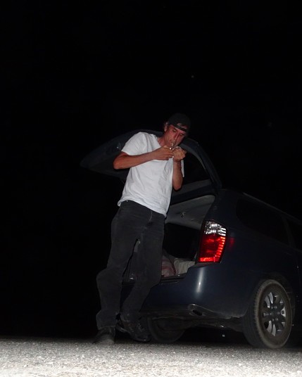 terry davis smoking with a backwards hat at night