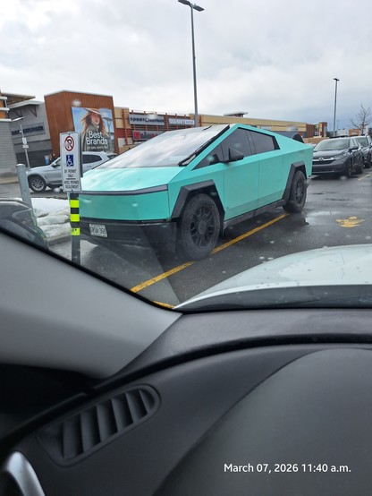 Ugly green Tesla cyber truck.