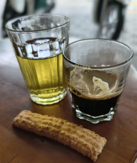 A caphe phin (black, hot coffee, no sugar for me), with hot tea and a cookie