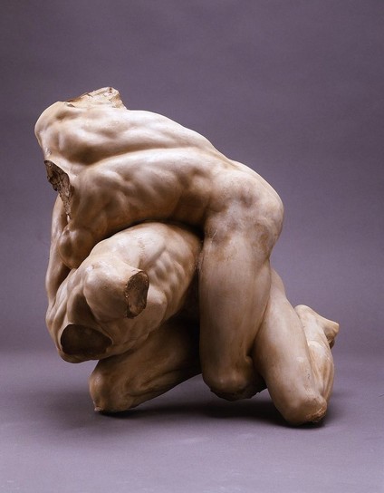 Fragment of The Wrestlers by Juan Adan Morland. sculpture of just the torsos and legs of two wrestlers wrapped on eachother. light pink-ish backdrop